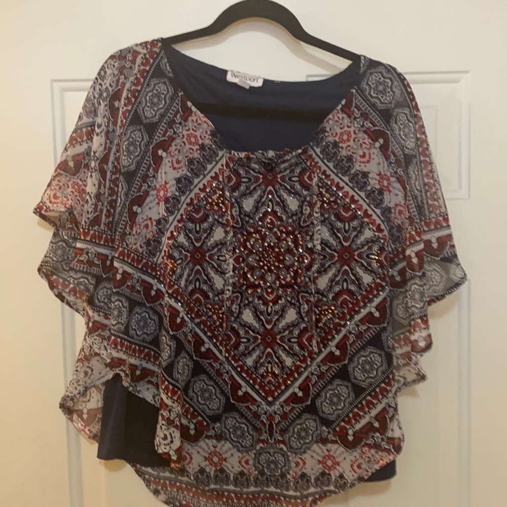 Dressy, flowing blue and red blouse.